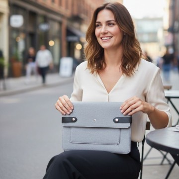 Housse ordinateur gris claire portée par une femme